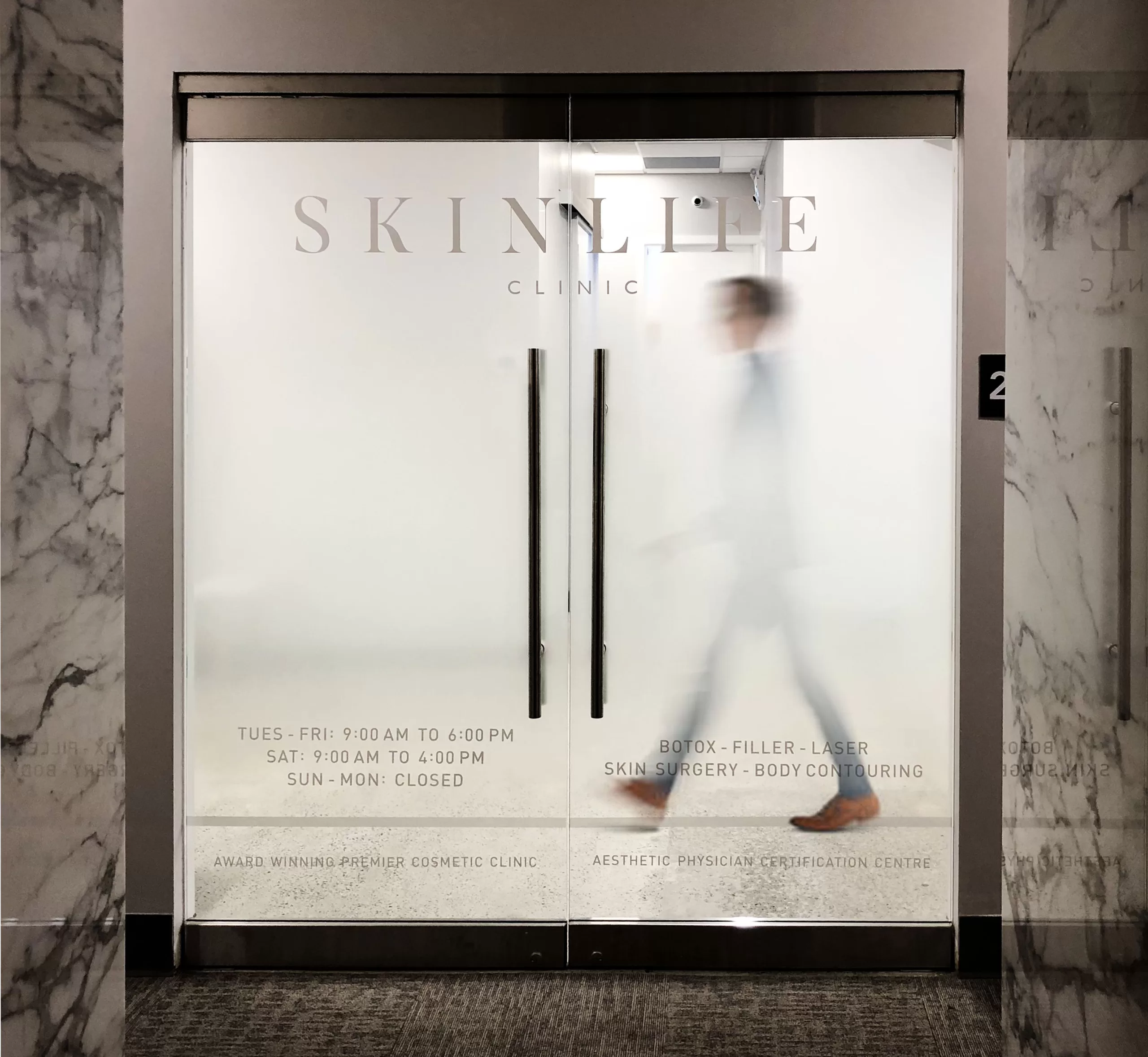 White lettering printed to optically clear vinyl with custom gradient frost.