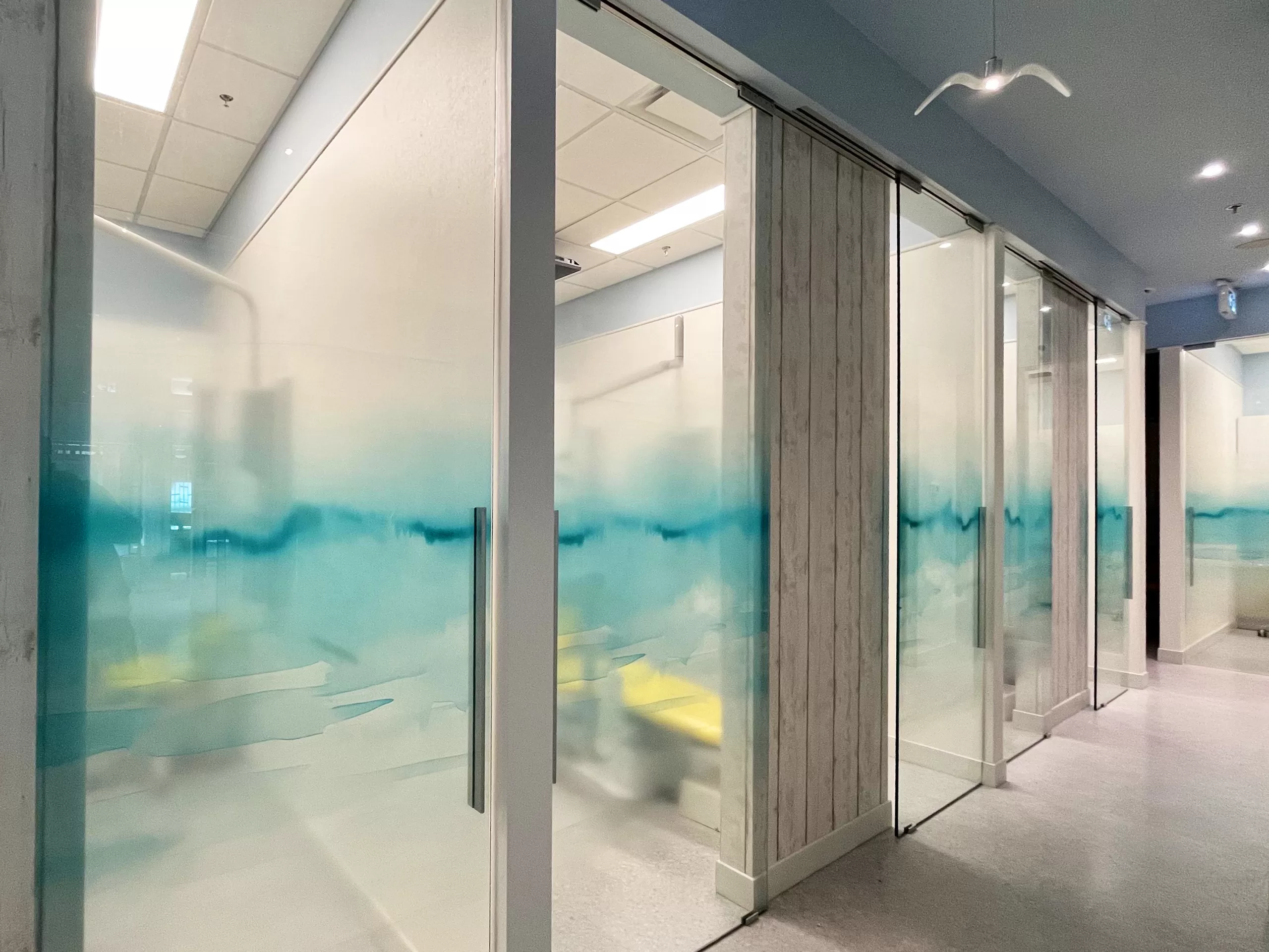 Custom white ink layered prints using optically clear vinyl as privacy film for a dental clinic.